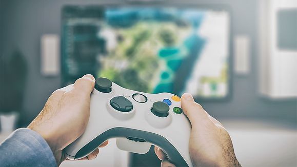 gaming game play tv fun gamer gamepad guy controller video console desktop playing player holding hobby playful enjoyment view concept - stock image